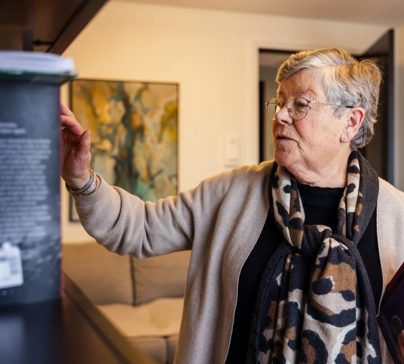 Bewoonster vertelt enthousiast in de woonkamer van Valckenborgh
